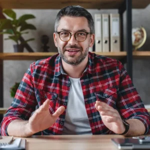 smiling-young-businessman-sit-at-desk-talk-on-webcam-having-video-call-or-conversation-with-client.webp smiling-young-businessman-sit-at-desk-talk-on-webcam-having-video-call-or-conversation-with-client.webp